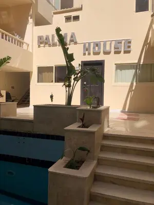 a building with stairs in front of a house at Beautiful apartment near sea 1+1 Dream Beach in Hurghada