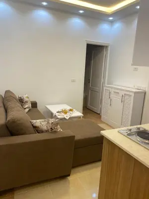 a living room with a couch and a table at Beautiful apartment near sea 1+1 Dream Beach in Hurghada