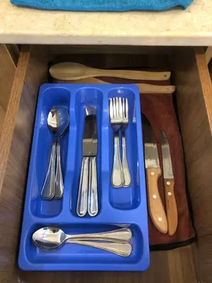 a blue tray with silver utensils on a table at Beautiful apartment near sea 1+1 Dream Beach in Hurghada