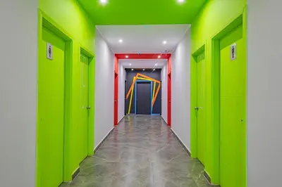 a hallway with green lockers and a colorful door at Bedcoin Hostel in Hurghada