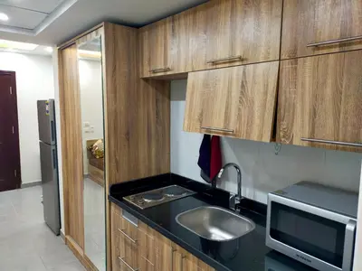 a kitchen with a sink and a microwave at شقة احلامك على البحر in Hurghada