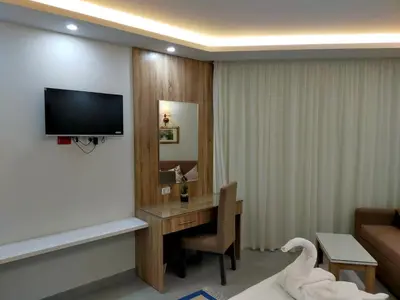 a room with a desk with a television and a swan at شقة احلامك على البحر in Hurghada