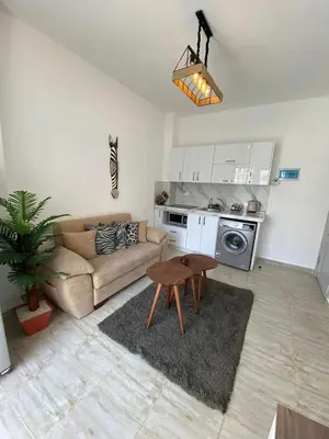 a living room with a couch and a table at 1 Bed Apartment - Balcony Pool Parking in Hurghada