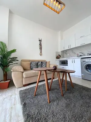 a living room with a couch and a coffee table at 1 Bed Apartment - Balcony Pool Parking in Hurghada