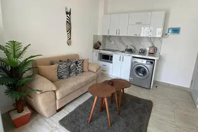 a living room with a couch and a table at 1 Bed Apartment - Balcony Pool Parking in Hurghada