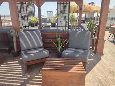 two chairs sitting on a patio with plants at Hurghada - Apartment - Sleeps 6 - Pool - Parking in Hurghada