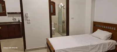 a bedroom with a bed and a bathroom with a mirror at Moon fourteen in Luxor