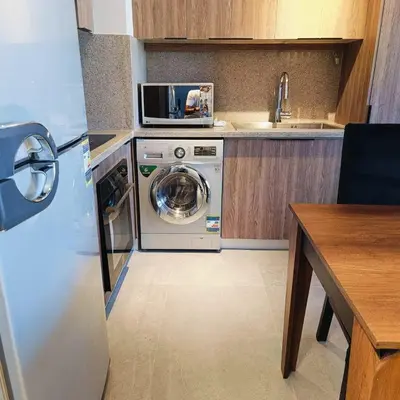 a kitchen with a washing machine and a sink at Nayah Stays, Luxurious bedroom in Fanadir Marina in Hurghada