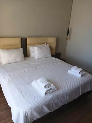 a bed with two towels and two pillows on it at Nayah Stays, Luxurious bedroom in Fanadir Marina in Hurghada