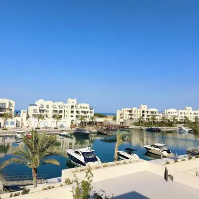 a view of a marina with boats in the water at Nayah Stays, Luxurious bedroom in Fanadir Marina in Hurghada
