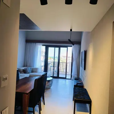 a living room with a table and a couch at Nayah Stays, Luxurious bedroom in Fanadir Marina in Hurghada