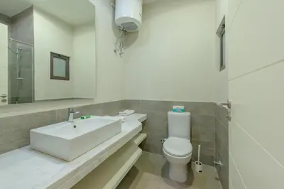 a white bathroom with a sink and a toilet at NEW! Gouna, Cyan Cozy 3BR Townhouse Lagoon & Pool in Hurghada