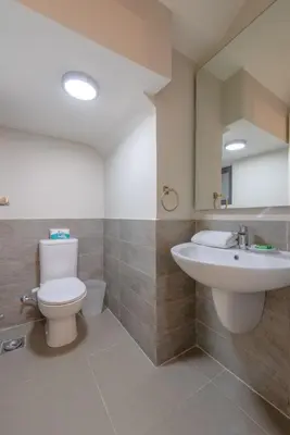 a bathroom with a toilet and a sink and a mirror at NEW! Gouna, Cyan Cozy 3BR Townhouse Lagoon & Pool in Hurghada