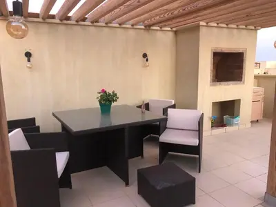 a dining room with a table and chairs at Penthouse in Hurghada