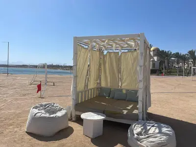 a bed in a tent on a beach at Penthouse in Hurghada