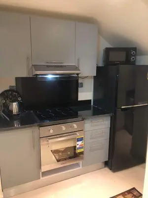 a kitchen with a stove and a refrigerator at Penthouse in Hurghada