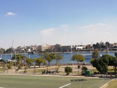 a tennis court next to a body of water at Nile Roof Hotel& Restaurant in Luxor
