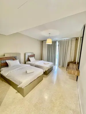 a bedroom with two beds and a window at Mangrove m3-1b-02 in Hurghada