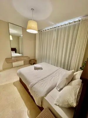 a bedroom with a large bed and a mirror at Mangrove m3-1b-02 in Hurghada
