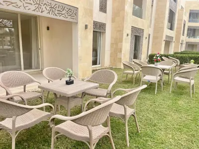 a row of tables and chairs on the grass at Mangrove m3-1b-02 in Hurghada