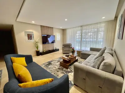 a large living room with a couch and a tv at Mangrove m3-1b-02 in Hurghada