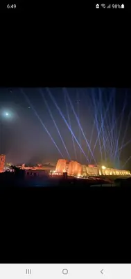 a view of a building with lights in the sky at Laila Flat in Al Aqālitah