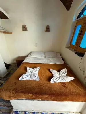 a bedroom with a bed with two white butterflies on it at Nubian King in Aswan