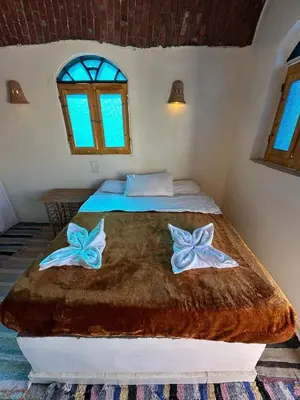 a bedroom with a bed with two bows on it at Nubian King in Aswan