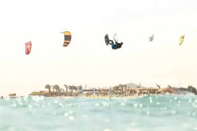 a group of kites flying over a beach at Mangroovy - 2BR La Blanca Pool View in Hurghada