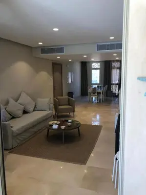 a living room with a couch and a table at Mangroovy - 2BR La Blanca Pool View in Hurghada