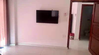 a flat screen tv hanging on a white wall at Moon House of Luxor in Luxor