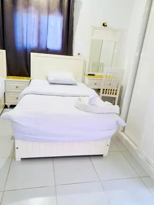 two white beds in a white room with a mirror at Moon House of Luxor in Luxor