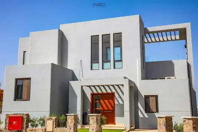 a white house with a red door at tawila t1-17 -5 bed room big villa in Hurghada