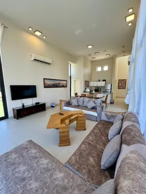 a living room with a couch and a tv at tawila t1-17 -5 bed room big villa in Hurghada