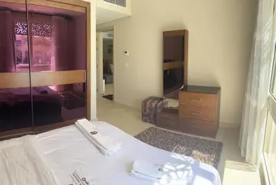 a bedroom with a white bed and a mirror at Mangroovy Comfy 2 Bedroom in Hurghada