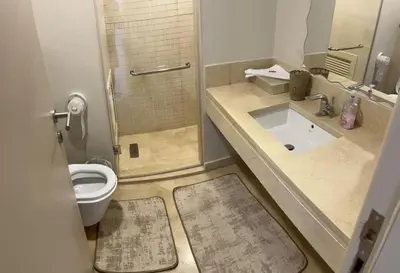 a bathroom with a toilet and a shower and a sink at Mangroovy Comfy 2 Bedroom in Hurghada
