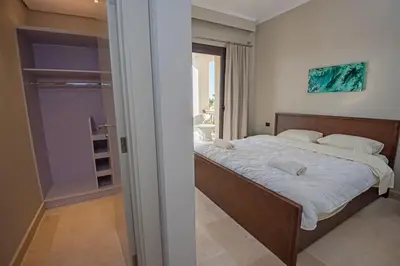 a bedroom with a large bed with white sheets at A S 2108 / 3 bedroom in Hurghada