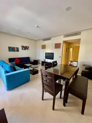 a living room with a table and a blue couch at A S 2108 / 3 bedroom in Hurghada