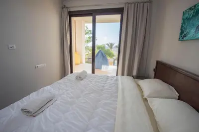a bed in a room with a large window at A S 2108 / 3 bedroom in Hurghada