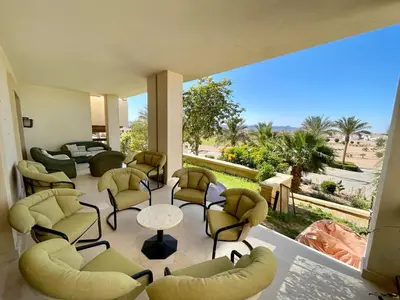 a living room with chairs and tables and a large window at A S 2108 / 3 bedroom in Hurghada