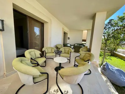a waiting room with yellow chairs and tables at A S 2108 / 3 bedroom in Hurghada