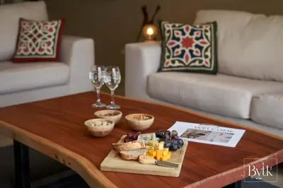 a coffee table with a tray of food and wine glasses at BYTK - La Galería in Hurghada