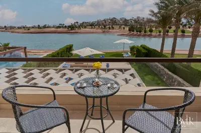 a table with two chairs and a view of a pool at BYTK - La Galería in Hurghada