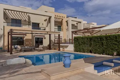 a villa with a swimming pool in front of a house at BYTK - La Galería in Hurghada