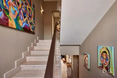 a staircase in a house with a painting on the wall at BYTK - La Galería in Hurghada