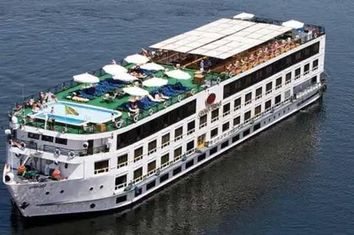 a cruise ship in the water with people on it at Cleopatra Nile Cruise in Luxor