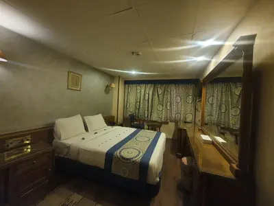 a small bedroom with a bed and a window at Ultra Nile Cruise 5 Star Luxor To Aswan in Luxor