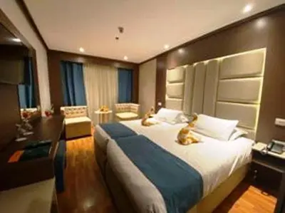a bedroom with a bed with two cats sitting on it at Ultra Nile Cruise 5 Star Luxor To Aswan in Luxor