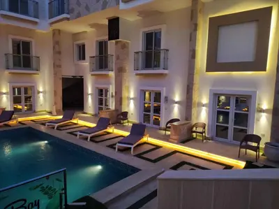 a hotel with a swimming pool and chairs next to a building at Boka Bay One in Hurghada