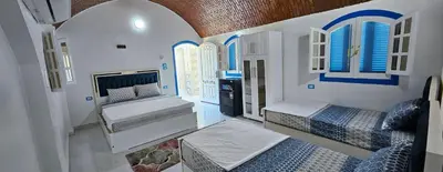 a room with two beds and two windows at La Terrace in Aswan